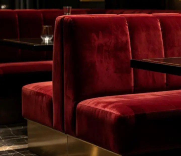 Intimate velvet-lined private booth prepared for a late-night function